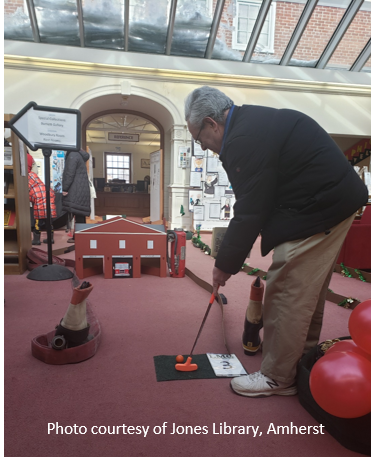 Person playing mini golf at a public library